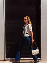 A lady wears flared jeans.